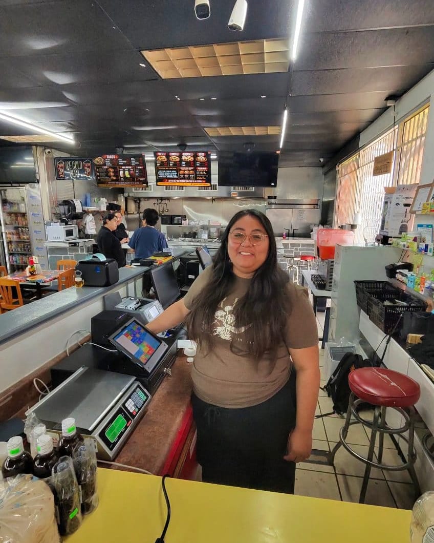 A staff member at the counter of La Moreliana Meat Market beside the new point-of-sale system